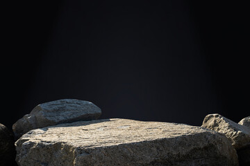 Poster - Stone rock podium pedestal on black background for spa, cosmetic product present,Minimal backdrop Studio background with grey rock sea stand and nature light on concrete wall for product showcase
