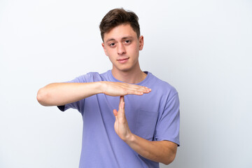 Wall Mural - Young handsome Brazilian man isolated on white background making time out gesture