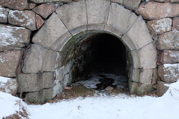 Wall Mural - A stone tunnel covered with snow, perfect for winter scenes or cold climates.