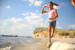 © New Africa - Cute little child with kite running on beach near sea. Spending time in nature