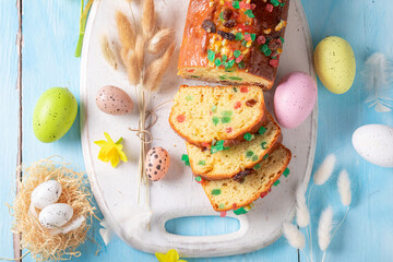 Wall Mural - Traditional Fruitcake for Easter surrounded by spring flowers aand eggs.