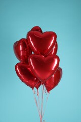 Poster - Many red heart-shaped balloons on light blue background. Happy Valentine's Day