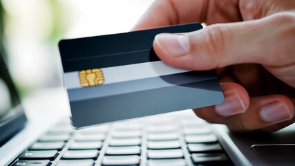 Female Hands with Credit Card close up. Online Shopping Concept. Laptop, Notebook on White Table. Winter Holidays Sale. Digital tablet device. Unrecognizable person sitting at table use online banking