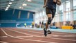 © Liana - A determined athlete with a prosthetic leg sprinting on an indoor track. The image represents strength, determination, adaptive sports, and overcoming challenges through resilience and dedication.