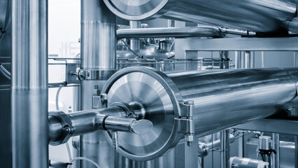 Poster - A close up of a group of metal pipes as industrial background. pipes are silver and have a shiny appearance. Concept of industrial Chemical pharmaceutical device