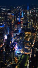 Wall Mural - Cityscape sparkling with billions of lights. Majestic New York panorama at night. Aerial perspective. Vertical video