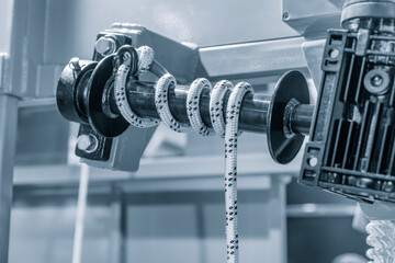 Poster - A rope is being pulled by a machine. The rope is white and black.  industrial concept background
