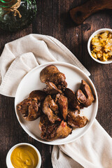 Wall Mural - Homemade stewed chicken liver on a plate on the table top and vertical view