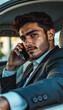 © Natalia - Confident young man in a suit making a phone call inside a luxury car