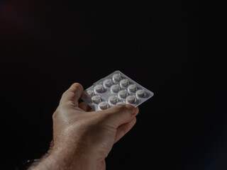 Poster - A person is holding a pill container with pills inside