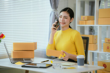 Portrait of Starting small businesses SME owners female entrepreneurs working on receipt box and check online orders to prepare to pack the boxes, sell