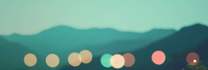 Aufkleber - Blurred mountain range with distant bokeh lights creating a vibrant backdrop