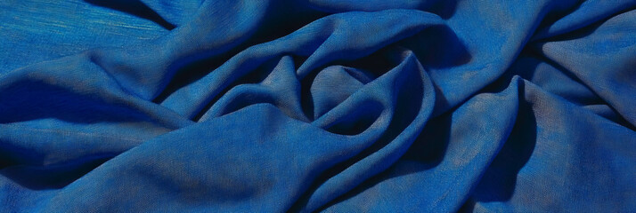 Poster - Deep indigo cotton fabric with chambray weave on bright background showcasing texture