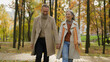 © Yuliia - Happy Caucasian family retired married couple 60s old mature woman man going walking in city park autumn nature carefree wife husband love romantic relationship intelligent female male stroll together