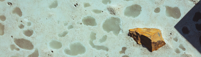 Poster - Unique salt finished concrete with exposed aggregate and decorative texture under bright light