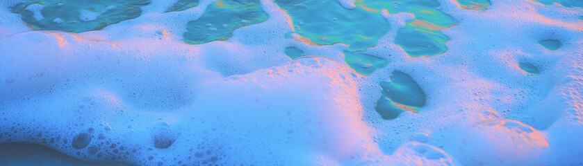 Aufkleber - Sea foam creates stunning textures on wet sand with vibrant neon highlights and colors
