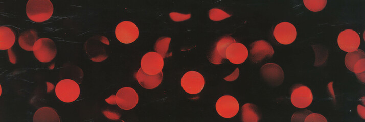 Aufkleber - Dotted red flickers create an enchanting visual display against a dark background