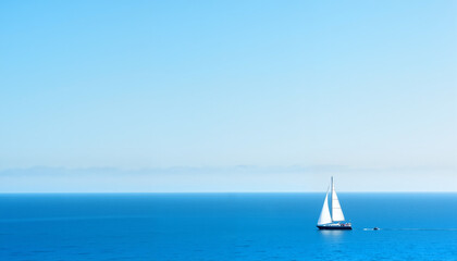  Sailboat gliding over calm blue waters under a clear sky