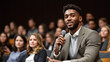 © Number One Studio - young man speaks confidently into microphone during conference, engaging with audience. room is filled with attentive listeners, creating dynamic atmosphere