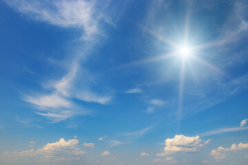 Wall Mural - sun on beautiful blue sky with fluffy clouds.