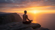 © Youniq - Yoga Practitioner Meditating at Sunrise on a Cliff.