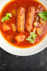 Wall Mural - Tomato soup with sausages fresh tasty food dish delicious gourmet food background on the table rustic food top view copy space