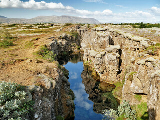 Wall Mural - Lagoon with crystal clear water in a crack in the earth's crust in Iceland