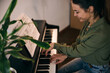 © milanmarkovic78 - Woman Playing Piano At Home