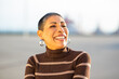 © Paula - Portrait of a smiling mature woman in striped sweater outdoors