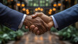 © samuel_miles - Successful business partnership established with a handshake in a modern, elegant space during a daytime meeting