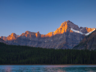 Wall Mural - mountains at dawn. nature. lake and high peaks in a mountain valley at dawn. natural landscape with 