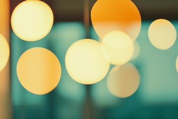 Poster - Golden Hour Bokeh: Abstract image of warm, glowing bokeh circles in yellow and orange hues, set against a blurred teal background, evoking a feeling of warmth and tranquility. 