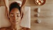 © Premium_art - A young Black woman receives a relaxing facial massage at a spa. Soft lighting and candles create a serene atmosphere.