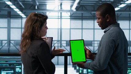 Poster - software developers in data center using mockup tablet, observing performance analytics charts. serv