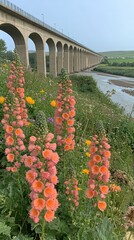 Canvas Print - Stunning Railway Viaduct and Vibrant Wildflowers Over a Serene Riverbank Landscape in Summer; Featuring Arched Bridge, Colorful Foxgloves, Countryside Scenery