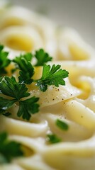 Wall Mural - parsley used as a garnish on top of a creamy pasta dish, intensifying the green color against the creamy white background