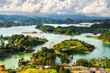 Wall Mural - Aerial view of Penol-Guatape Reservoir in Colombia, showcasing its vibrant landscapes lush green hills and a network of shimmering turquoise lakes