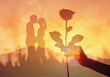 © kieferpix - Feeling in love, hand with rose , Valentine's Day background,  couple kissing the sunset