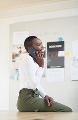 Fototapete - Black woman, phone call and happy in office for talk, networking and thinking at startup company. African person, smartphone and smile with contact, progress and report for project at event agency