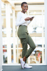 Poster - Black woman, phone and texting at startup with smile, portrait and contact for deal, networking or chat. Person, smartphone and happy on balcony with mobile app on break at creative agency in Kenya