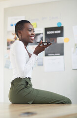 Fototapete - Black woman, speaker phone call and smile in office with talk, networking and planning at startup. African person, smartphone and happy with voice note, chat and schedule for project at event agency