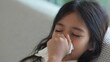 © FAMILY STOCK - Asian child girl sick with sneezing on the nose and cold cough on tissue paper because weak or virus and bacteria from dust weather and Air pollution pm2.5