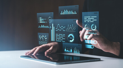 Poster - Interactive digital data visualization panels being accessed by a hand on a tablet on a dark background. Concept of futuristic technology.