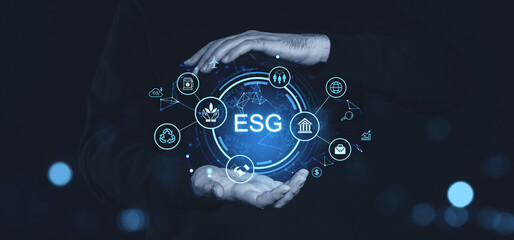Poster - Businessman's hands holding glowing ESG symbols on a dark background.