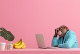 A monkey in a blue suit sitting at a desk with a laptop and bananas, looking stressed.