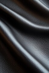 Poster - Detailed folds of black leather reflect dramatic lighting, showcasing deep shadows and smooth highlights, ideal for design and artistic exploration. Text can be seamlessly added