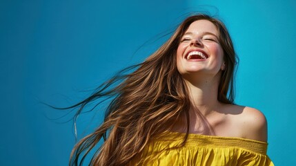 smiling woman with long hair against a blue background, showcasing joy and confidence in a sunny out