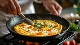 A chef making a perfect omelet with cheese, herbs, and vegetables inside 