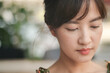 © Jirawatfoto - close up of thoughtful Asian young woman with natural makeup, soft lighting, and blurred background, creating serene and introspective mood