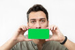 © Vitaliy - Upset man holds smartphone with green screen in front of his face